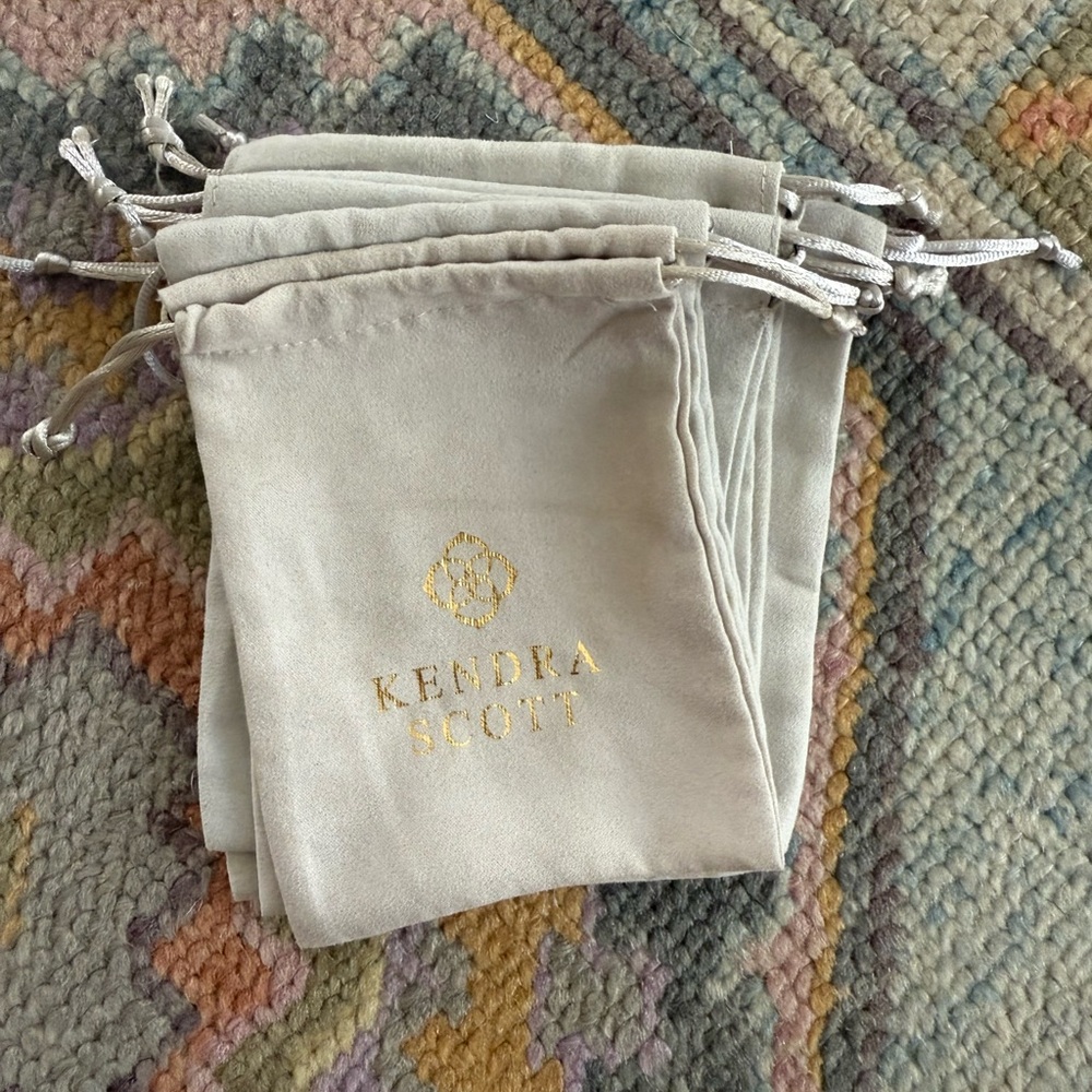6 Kendra Scott Cream Pouches with Gold Logo